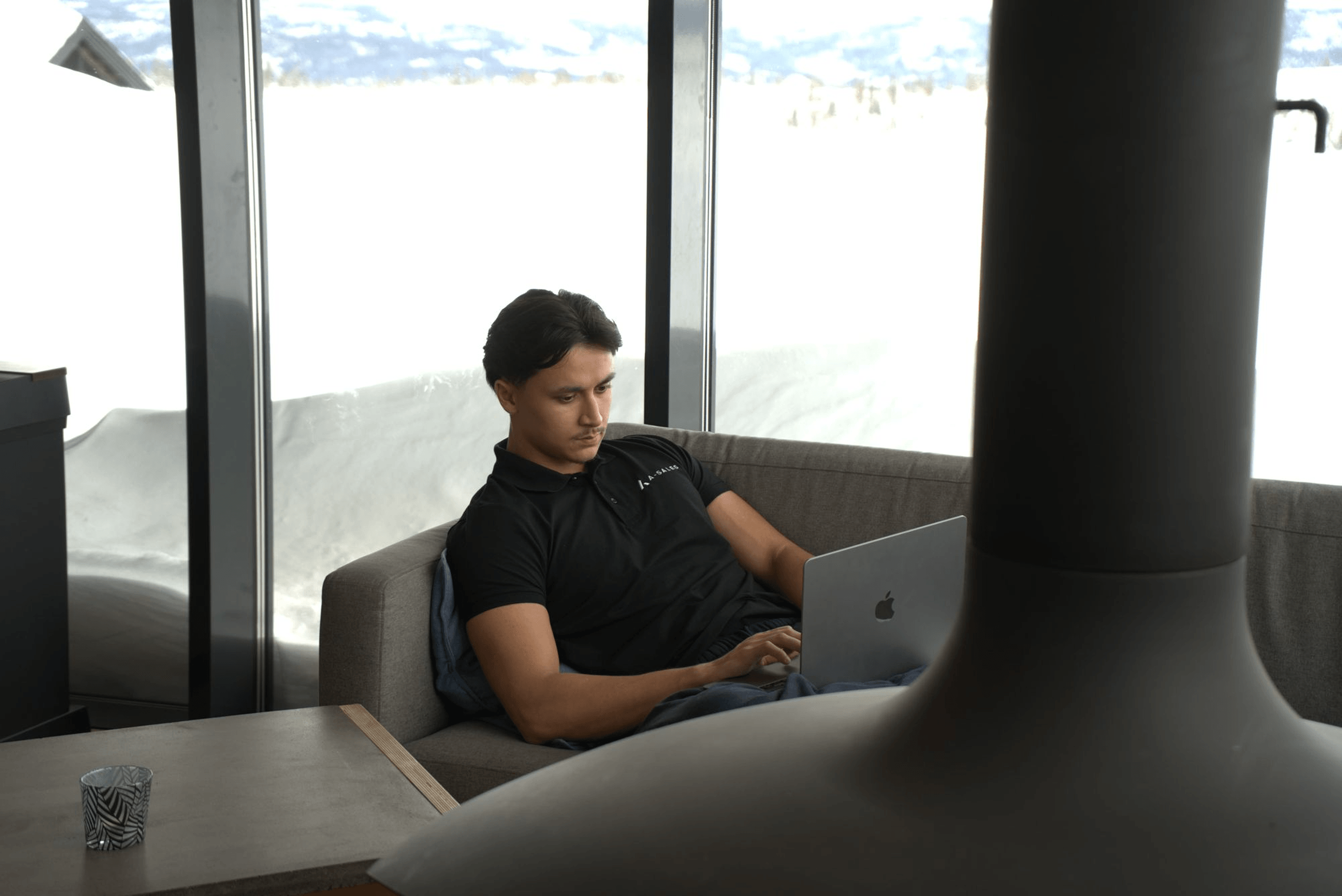 An A-Sales team member working on a laptop at the Stockholm office